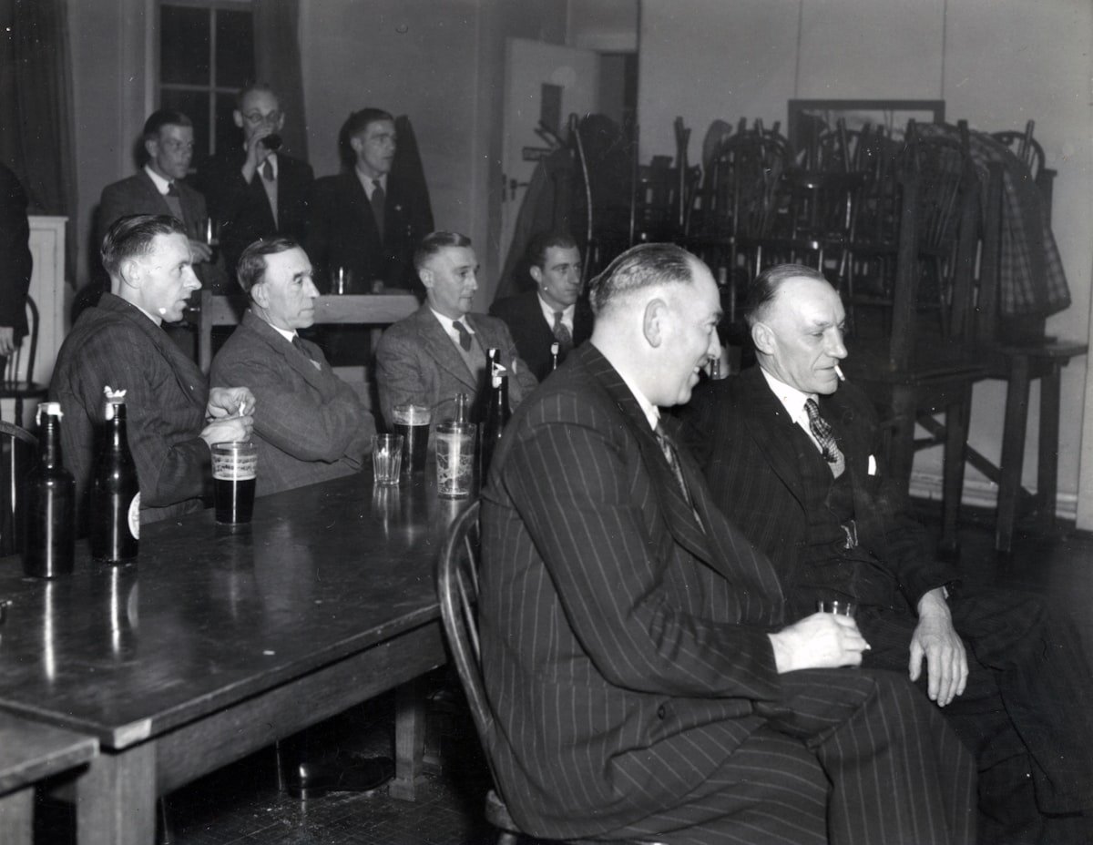 Lads enjoying drinks at a pub on a stag night out